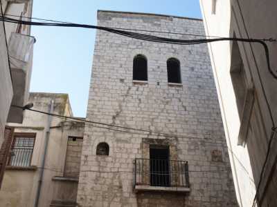 ...due ai piani superiori sormontate da archi lunati a tutto sesto e una al primo piano che si sporge su un balconcino in muratura dalla ringhiera in ferro